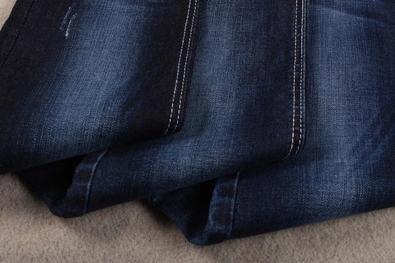 Prezzo buono Un materiale elastico di 339 di GSM 10 Oz di tocco morbido dell'indaco del cotone del ringrosso del denim blue jeans del tessuto in linea